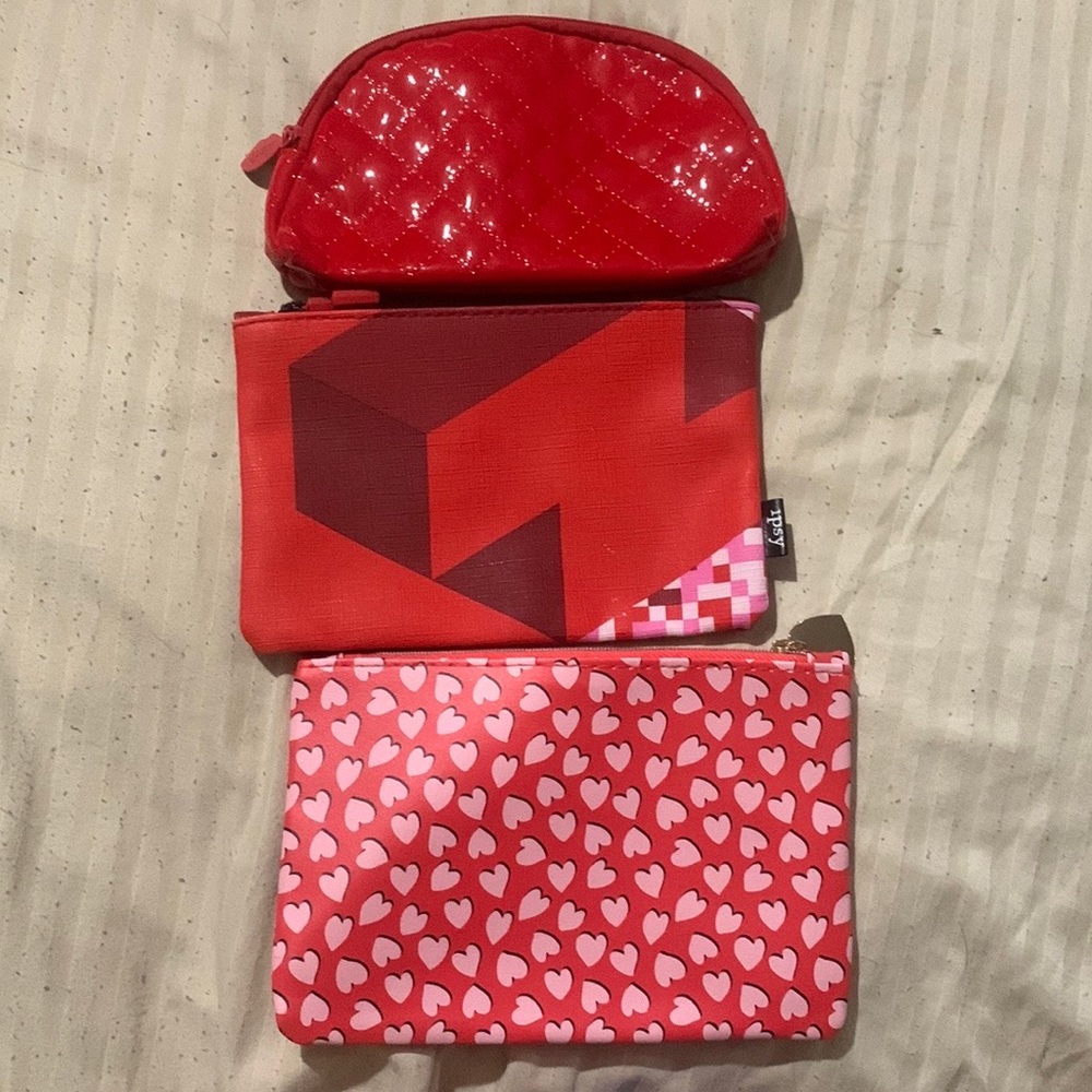 Set of three ipsy cosmetic bags.